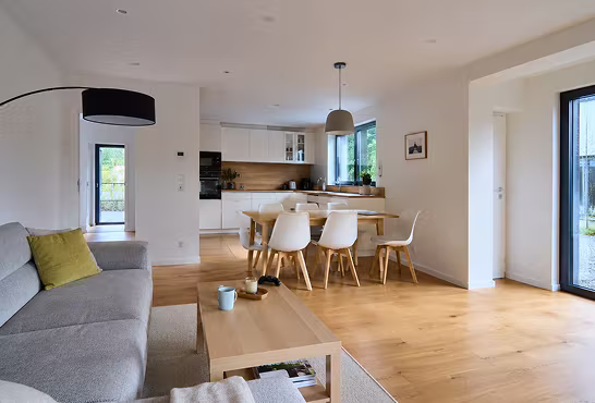 Bright open-plan living room with kitchen and dining area